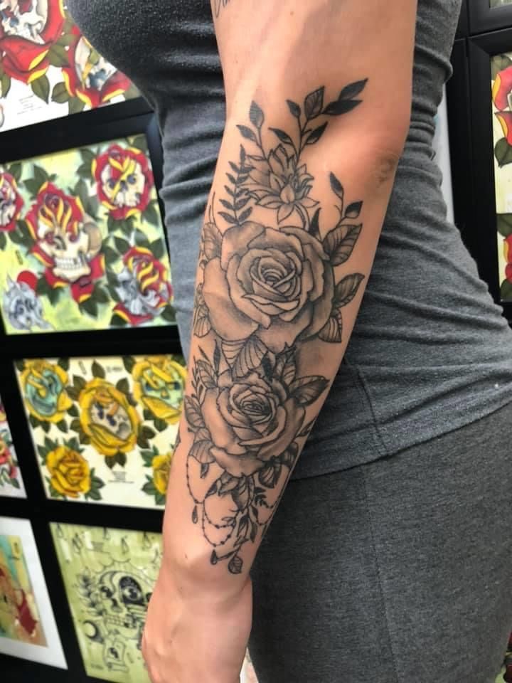 Half Sleeve Tattoo Depicting Flowers